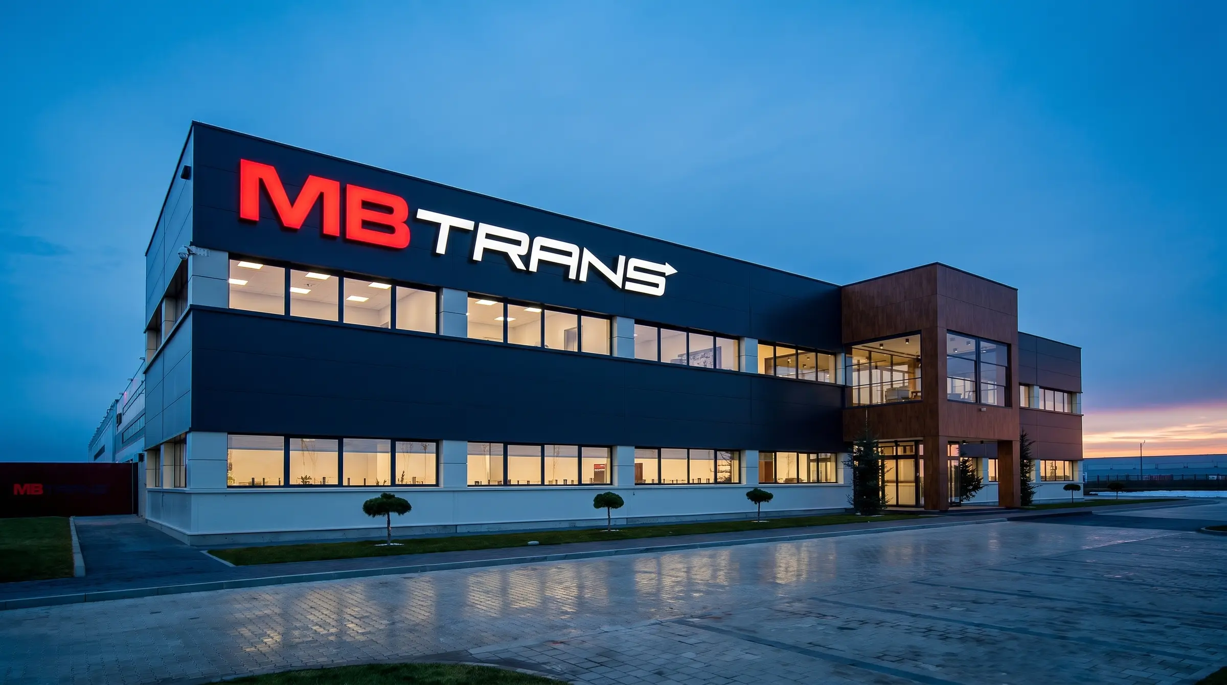 Upravna zgrada MB TRANS sa crvenim natpisom, u plavi čas
